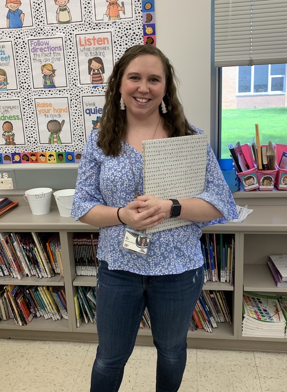 happy teacher in classroom